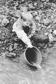 [photo of student releasing fish.]